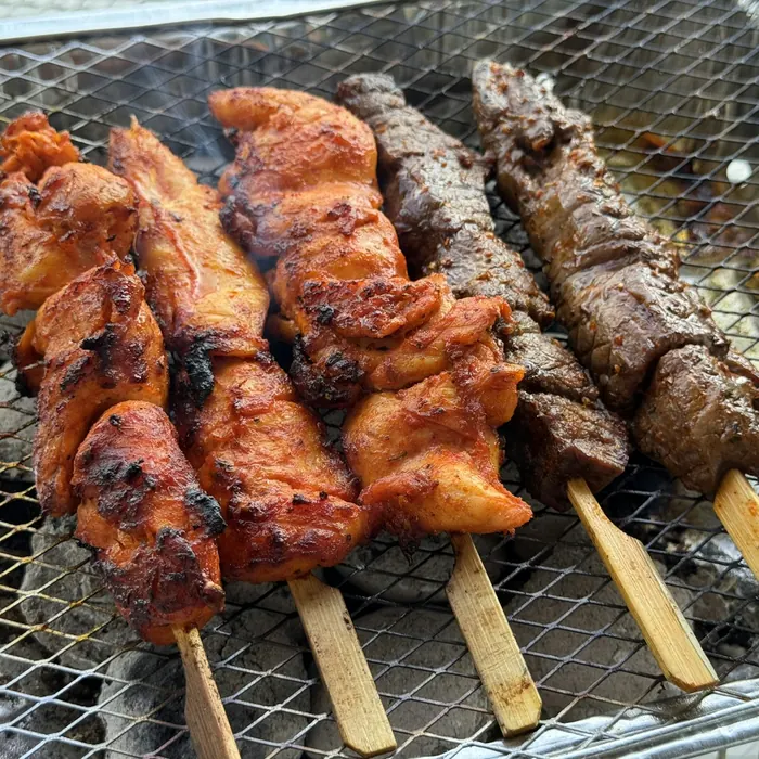 Meat cooking on a charcoal grill (stock photo)