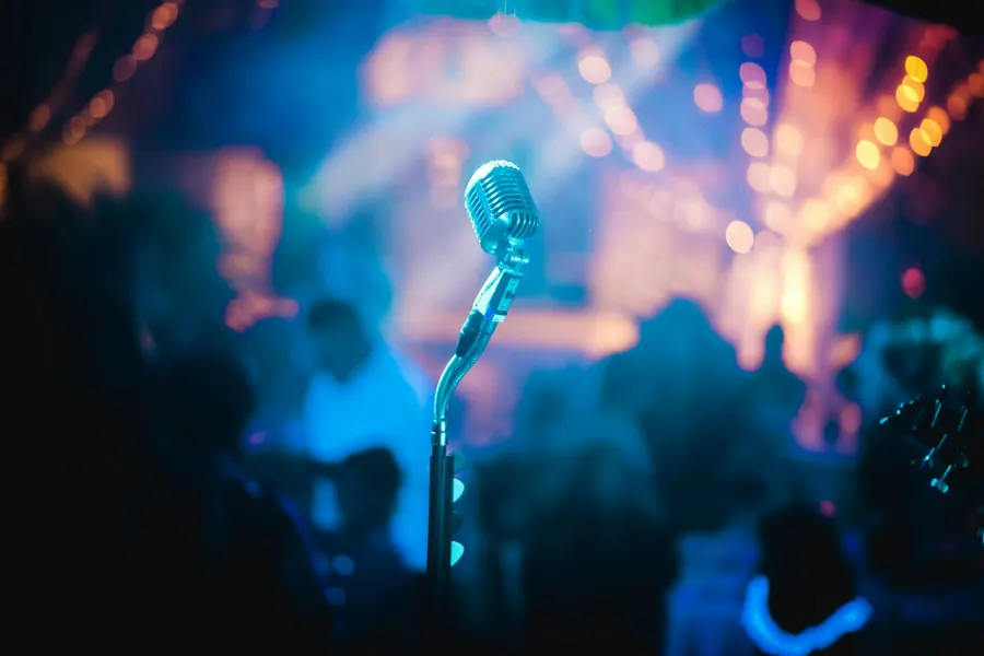 Microphone on a stage under coloured lights (stock photo)